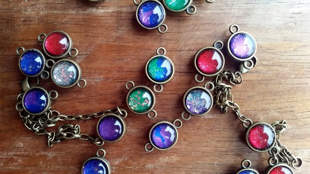 Handmade glass cabochon charms that resembles miniature galaxy